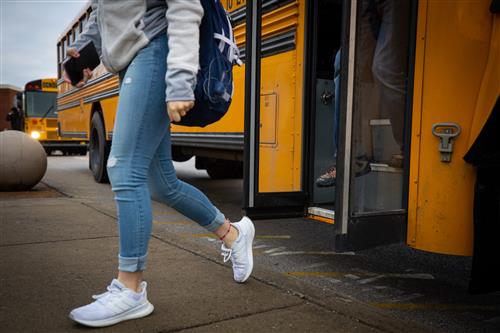 Child getting off bus